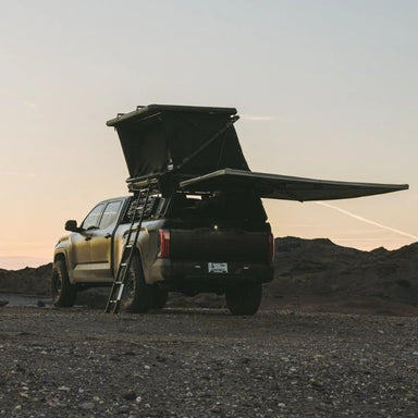 freespirit-recreation-evolution-v2-xl-hard-shell-roof-top-tent-black-open-rear-corner-view-on-toyota-tundra-in-the-mountains
