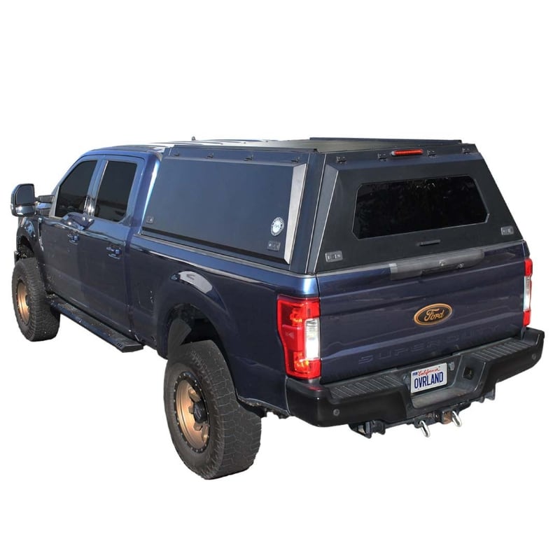 overland-vehicle-systems-expedition-truck-cap-for-ford-f250-f350-4th-gen-rear-corner-view-on-white-background