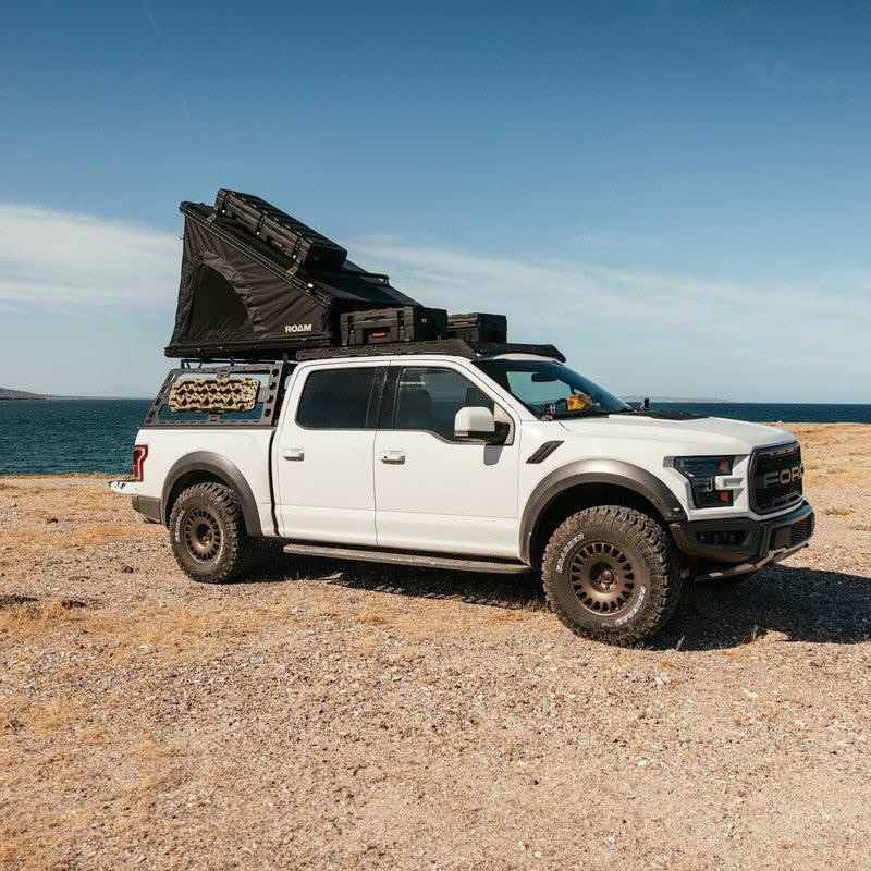 roam-desperado-hardshell-rooftop-tent-open-side-view-on-vehicle-in-nature