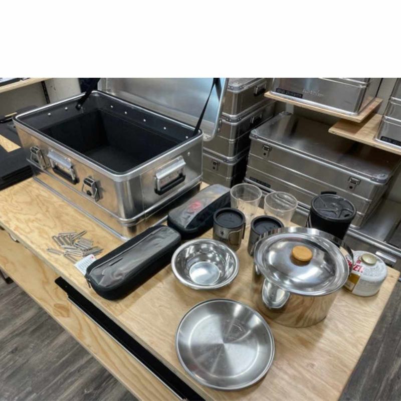 alubox-case-divider-system-black-front-corner-view-inside-aluminum-case-with-kitchenware-in-warehouse