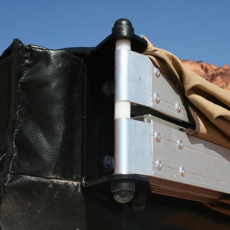 eezi-awn-bat-270-awning-beige-close-rear-corner-close-up-view-with-hinge-in-nature