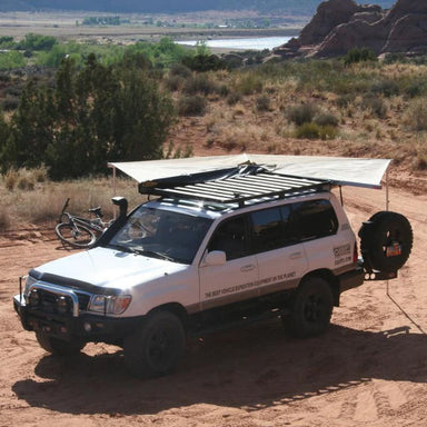 eezi-awn-bat-270-awning-beige-open-front-top-corner-view-ont-op-of-land-cuiser-in-terrain