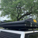 eezi-awn-blade-40th-edition-hard-shell-roof-top-tent-closed-rear-corner-view-on-vehicle-in-nature