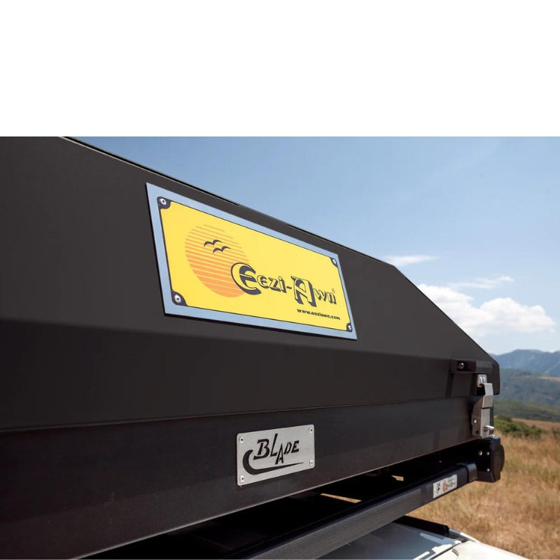 eezi-awn-blade-hard-shell-roof-top-tent-closed-close-up-view-on-vehicle-in-nature