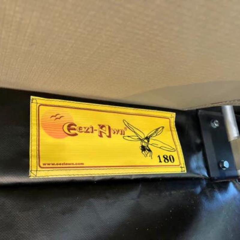 eezi-awn-dragonfly-180-open-beige-interior-close-up-view-with-brand-logo