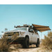 eezi-awn-dragonfly-mini-180-awning-beige-open-front-rear-corner-view-in-nature
