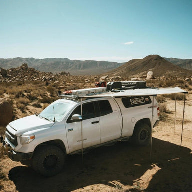 eezi-awn-dragonfly-mini-180-awning-beige-open-sider-view-in-nature
