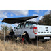 eezi-awn-dragonfly-mini-180-awning-gray-open-rear-corner-view-with-person-in-nature