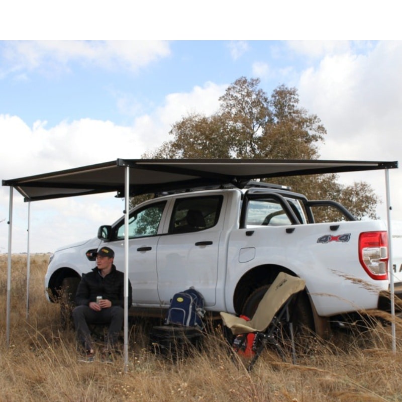 eezi-awn-dragonfly-mini-180-awning-gray-open-rear-side-view-with-person-in-terrain