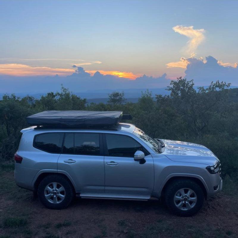 eezi-awn-galaxy-soft-shell-rooftop-tent-closed-front-view-on-toyota-land-cruiser-view-in-nature