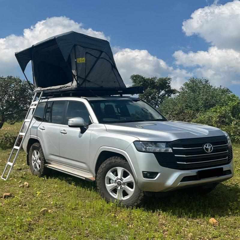 eezi-awn-galaxy-soft-shell-rooftop-tent-open-front-corner-view-in-nature