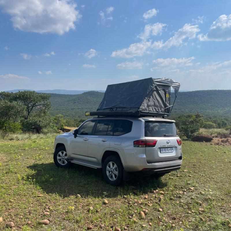 eezi-awn-galaxy-soft-shell-rooftop-tent-open-rear-corner-view-on-toyota-land-cruiser-view-in-nature