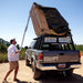 eezi-awn-jazz-soft-shell-roof-top-tent-closed-rear-view-on-vehicle-with-person-in-nature