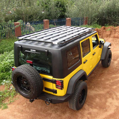 eezi-awn-k9-roof-rack-for-jeep-wrangler-jk-rear-corner-view-with-fence-in-nature