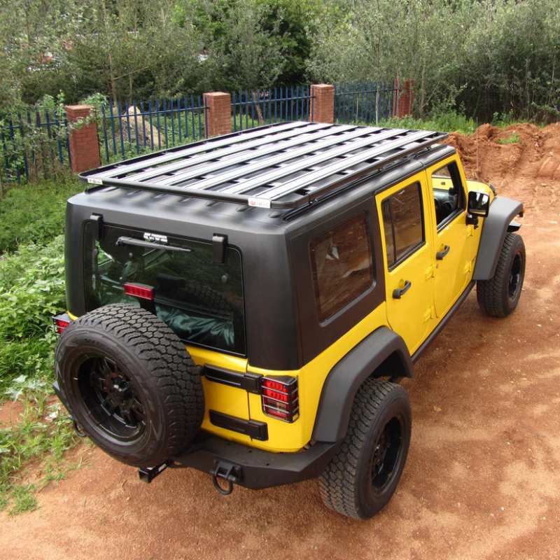 eezi-awn-k9-roof-rack-for-jeep-wrangler-jk-rear-corner-view-with-fence-in-nature