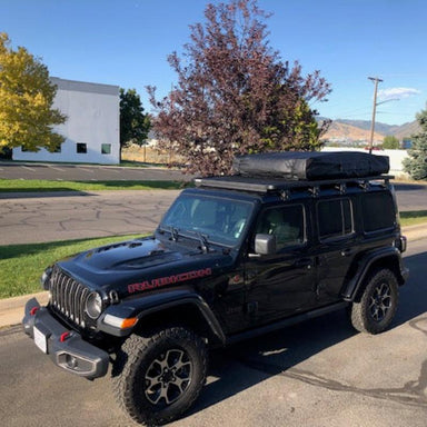 eezi-awn-k9-roof-rack-for-jeep-wrangler-jl-front-corner-view-with-tent-in-parking-area