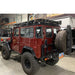 eezi-awn-k9-roof-rack-for-toyota-land-cruiser-40-series-rear-view-with-tire-and-maxtrax-inside-shop