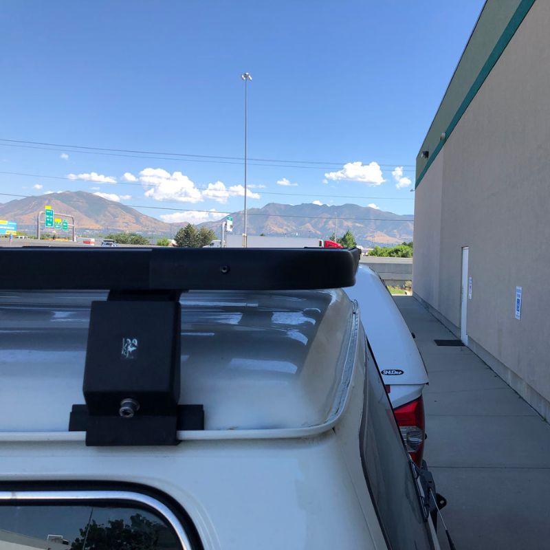 eezi-awn-k9-roof-rack-for-toyota-land-cruiser-60-close-up-view-with-roof-rack-leg-on-parking-lot
