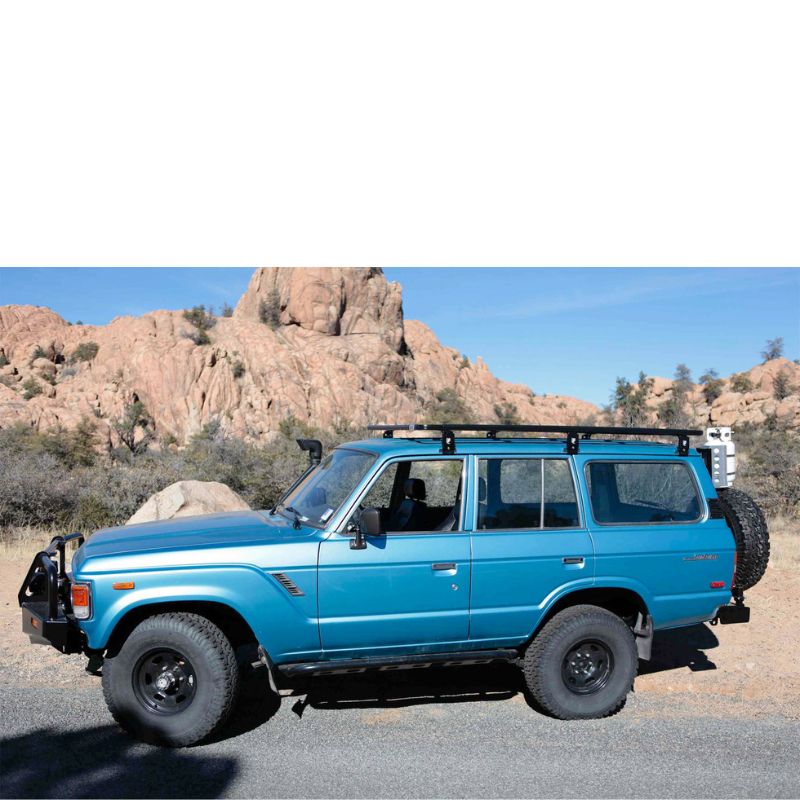 eezi-awn-k9-roof-rack-for-toyota-land-cruiser-60-side-view-on-blue-land-cruiser-in-terrain