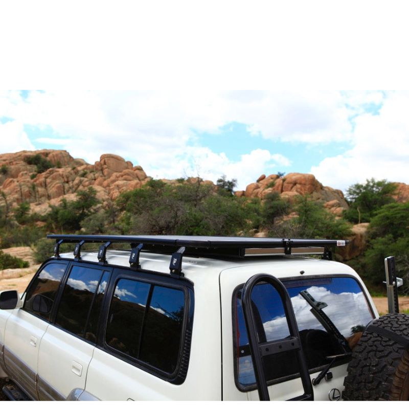 eezi-awn-k9-roof-rack-for-toyota-land-cruiser-80-series-rear-view-with-spare-tire-in-nature