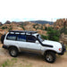 eezi-awn-k9-roof-rack-for-toyota-land-cruiser-80-series-side-view-in-terrain