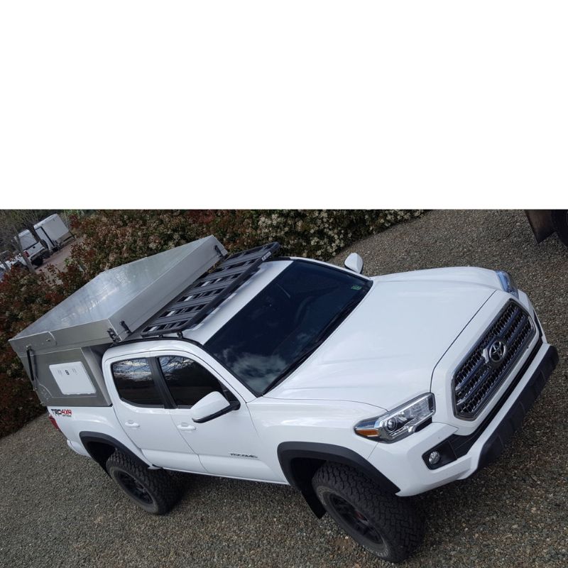 eezi-awn-k9-roof-rack-for-toyota-tacoma-front-corner-view-with-truck-cap-and-roof-top-tent-on-lawn