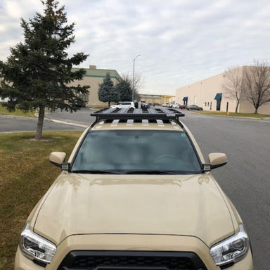 eezi-awn-k9-roof-rack-for-toyota-tacoma-front-view-with-building-and-cars-on-background