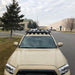 eezi-awn-k9-roof-rack-for-toyota-tacoma-front-view-with-building-and-cars-on-background