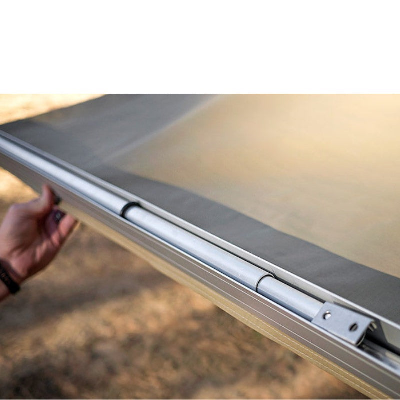 eezi-awn-lite-awning-beige-open-close-up-view-folded-aluminum-legs-in-nature