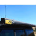 eezi-awn-manta-270-awning-beige-close-with-enclosure-top-corner-view-on-land-cruiser-with-brand-sticker-in-nature
