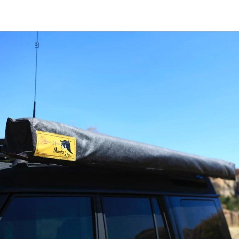 eezi-awn-manta-270-awning-beige-close-with-enclosure-top-corner-view-on-land-cruiser-with-brand-sticker-in-nature