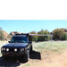 eezi-awn-manta-270-awning-beige-open-front-view-on-land-cruiser-in-nature