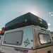 eezi-awn-sabre-hard-shell-roof-top-tent-closed-rear-corner-view-on-vehicle-in-nature