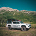 eezi-awn-sabre-hard-shell-roof-top-tent-closed-side-view-on-vehicle-in-nature