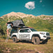 eezi-awn-sabre-hard-shell-roof-top-tent-open-side-view-on-vehicle-with-person-in-the-mountains