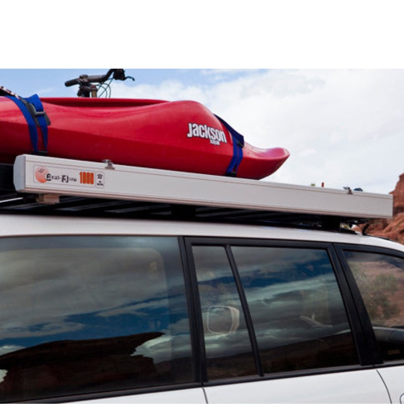 eezi-awn-series-1000-awning-close-side-view-silver-hardcase-on-lan-cruiser-beside-kayak-in-nature