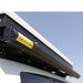 eezi-awn-series-2000-awning-close-side-view-black-hardcase-beside-hard-shell-tent-on-vehicle-in-nature