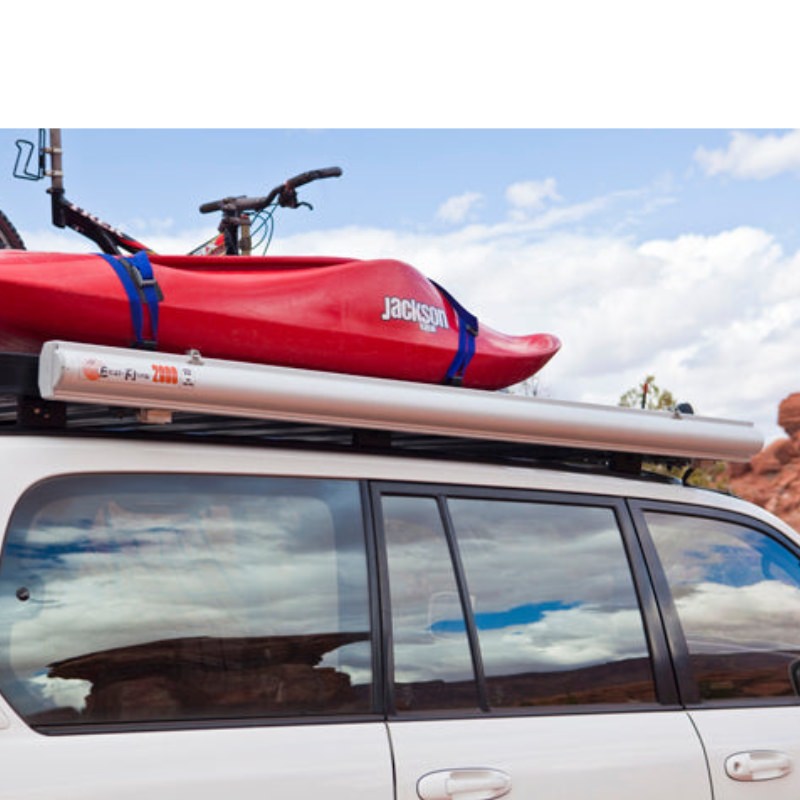 eezi-awn-series-2000-awning-close-side-view-silver-hardcase-on-vehicle-beside-bike-and-kayak-terrain