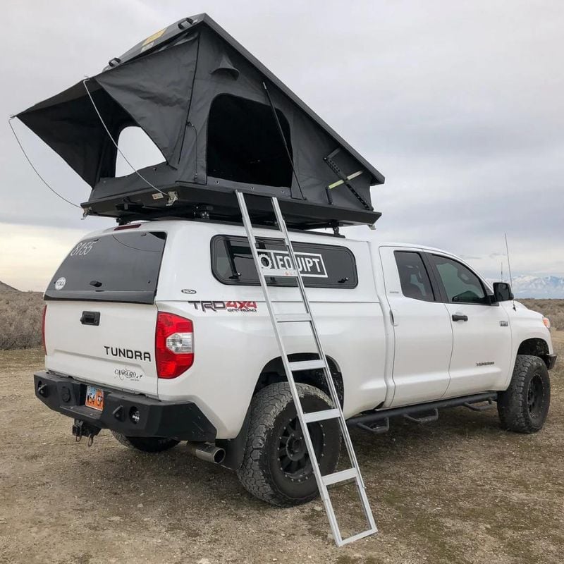 eezi-awn-stealth-hard-shell-roof-top-tent-open-rear-corner-view-with-pitched-rainfly-on-toyota-tundra-in-desert