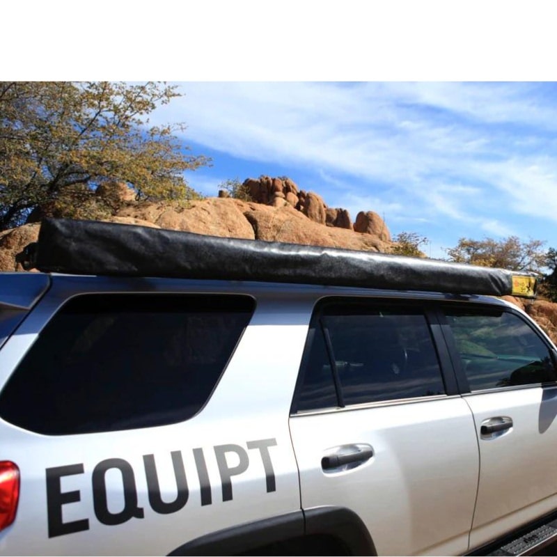 eezi-awn-swift-awning-beige-close-front-corner-side-view-with-enclosure-on-toyota-4runner-in-terrain