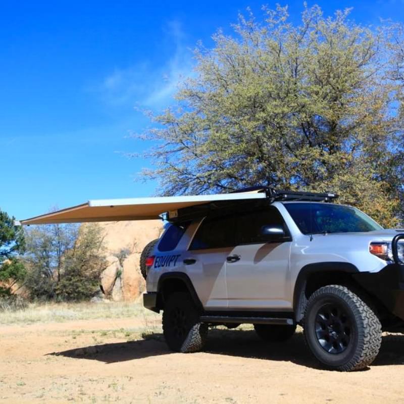 eezi-awn-swift-awning-beige-open-rear-front-corner-view-freestanding-on-toyota-4runner-in-terrain