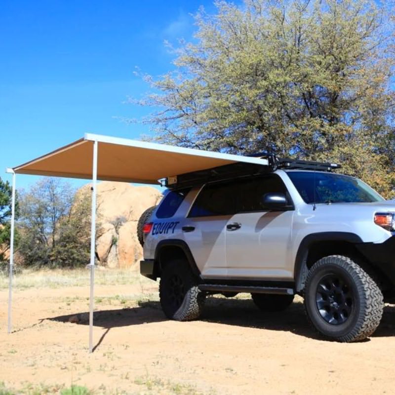 eezi-awn-swift-awning-beige-open-rear-front-corner-view-on-toyota-4runner-in-nature