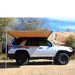 eezi-awn-swift-awning-beige-open-rear-side-veiw-on-toyota-4runner-in-nature