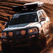 eezi-awn-sword-hard-shell-roof-top-tent-closed-front-view-on-vehicle-in-desert