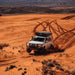 eezi-awn-sword-hard-shell-roof-top-tent-closed-front-view-on-vehicle-in-sandy-terrain