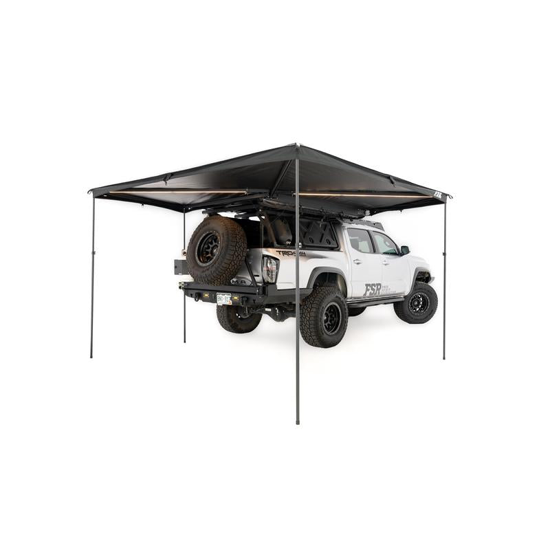 freespirit-recreation-270-awning-v2-open-rear-corner-view-with-poles-deployed-on-toyota-tacoma-on-white-background