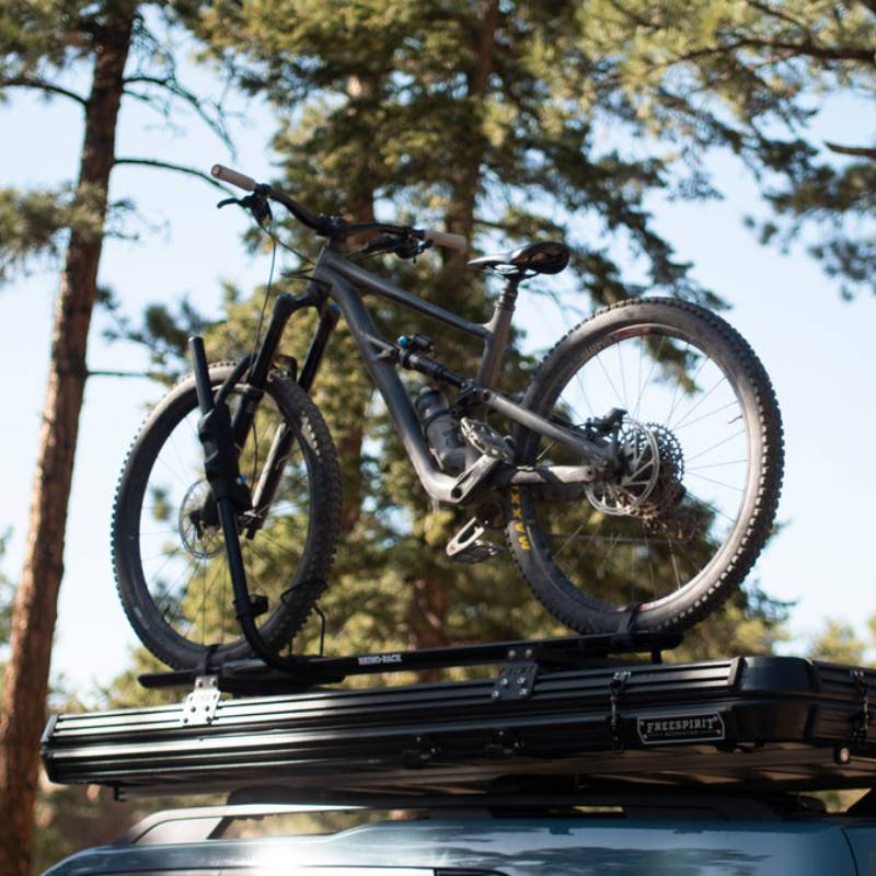 freespirit-recreation-aspen-v2-standard-hard-shell-roof-top-tent-black-closed-on-top-of-vehicle-with-bike-in-nature