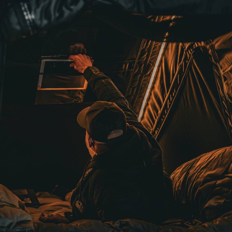 freespirit-recreation-aspen-v2-standard-hard-shell-roof-top-tent-black-open-interior-view-with-man-and-led-light-strip