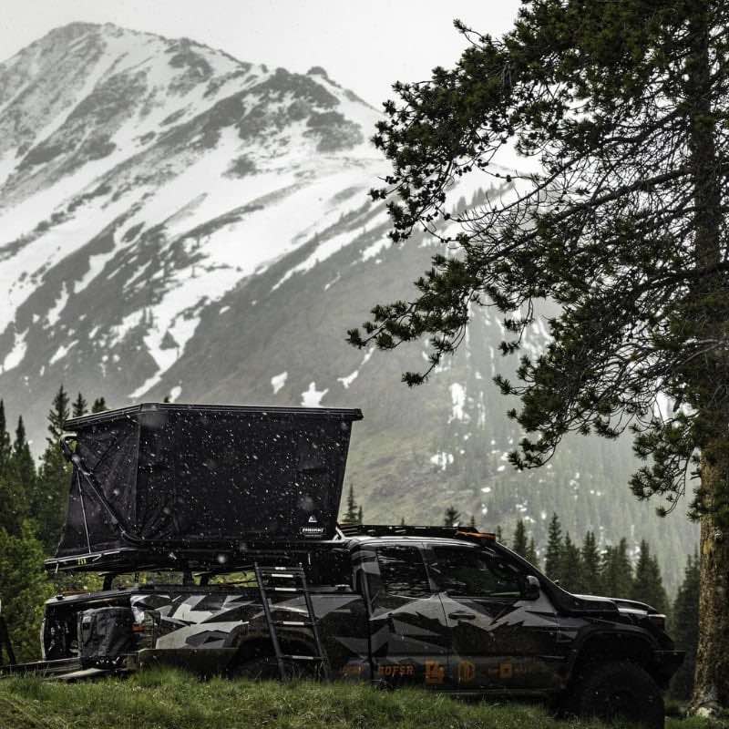 freespirit-recreation-evolution-v2-standard-hard-shell-roof-top-tent-black-open-rear-corner-view-on-truck-in-mountains-with-snow