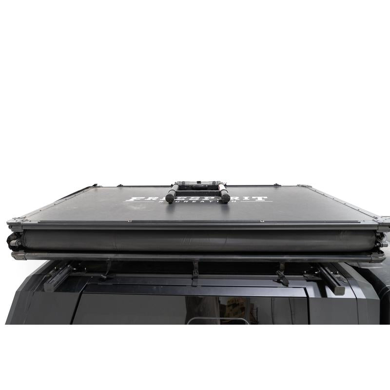 freespirit-recreation-high-country-v2-king-soft-shell-roof-top-tent-black-closed-front-view-with-collapsed-ladder-on-toyota-tundra-on-neutral-background